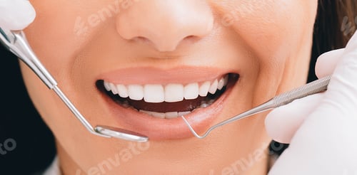 Preview: Cropped perfect smile and dentist hands holding a dental equipment and an angle mirror. Dentistry