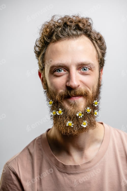 Preview: Satisfied cheerful handsome man smiles at camera isolated over white background.