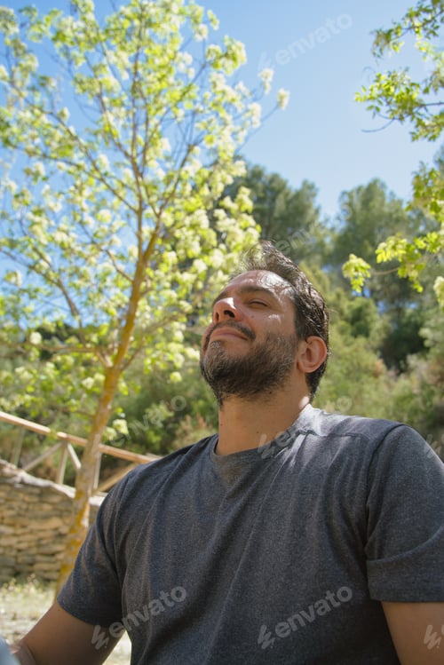 Preview: Man reconnecting with nature. Breathing fresh air outdoors