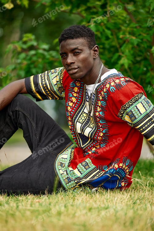 Preview: An African man in South African national clothes, a black young man resting in a park in national