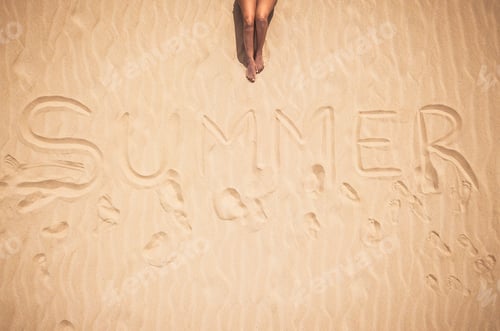 Preview: Summer holiday travel vacation with woman legs laying and relaxing on the sand beach alone
