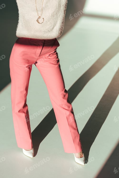 Preview: cropped shot of girl in pink clothes posing in studio