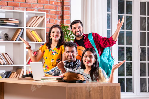 Preview: Indian asian four college or university students using laptop together