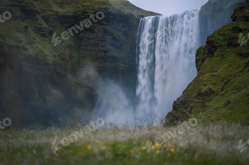 Preview: The most popular waterfall in Iceland - Skogafoss. Water rushes down with a crash, forming a cloud
