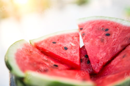 Preview: Juicy bright red pieces of sliced watermelon on a black table background.