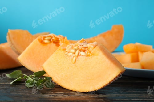 Preview: Concept of fresh food with melon pieces on rustic wooden table