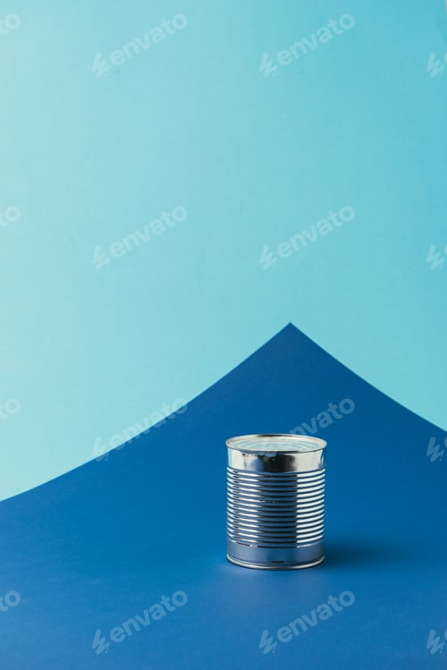 Preview: close up view of metal can on blue background, recycle concept