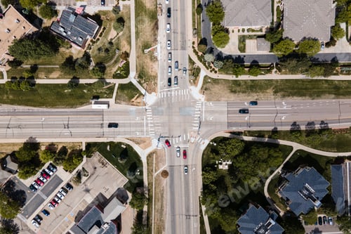 Preview: Aerial view of cross roads, cars and cityscape on a sunny day