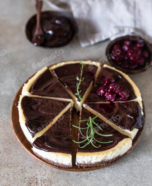 Preview: Classic creamy cheesecake with chocolate ganache, cherries and rosemary. Popular festive dessert.