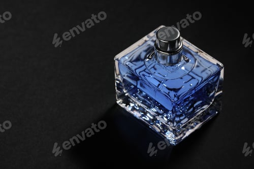 Preview: Blue men's perfume in bottle on black background, space for text