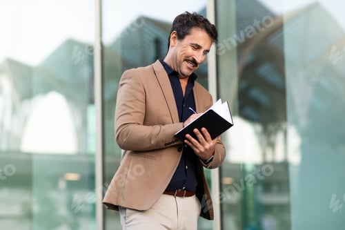 Preview: Positive middle aged businessman walking by street, taking notes