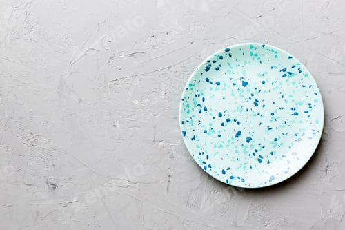 Preview: Top view of empty blue plate on cement background. Empty space for your design