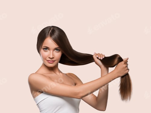 Preview: Beautiful smooth hair long brunette hairstyle woman healthy skin. Color background. Pink