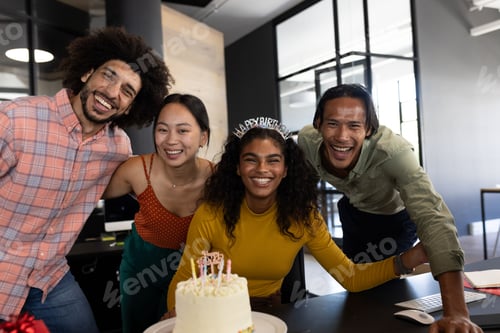 Preview: In office, colleagues gathering around cake, celebrating birthday with decorations