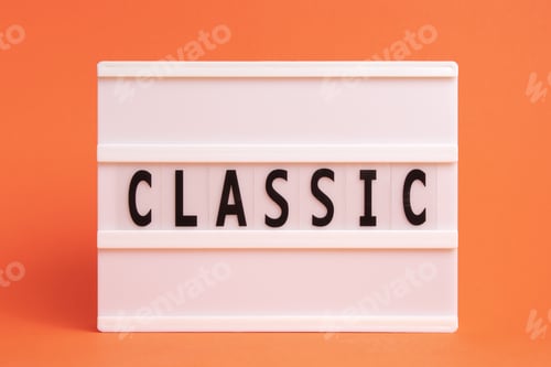 Preview: The word classic on lightbox isolated orange background. Literary Genres