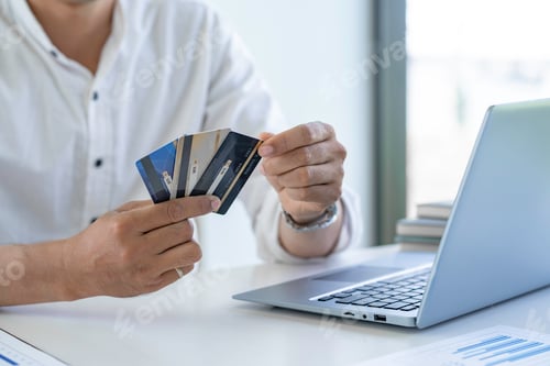 Preview: Business man choosing the right credit card for online spending, Online payment, man hands holding a