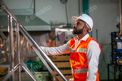 Preview: professional technician engineer with safety hard hat working in industrial factory.