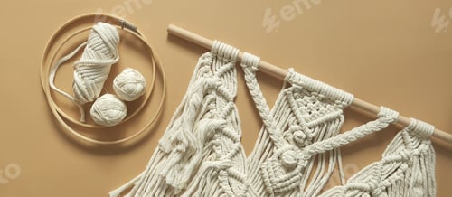 Preview: Macrame. Handmade macrame weaving and cotton threads on a rustic wooden stick.