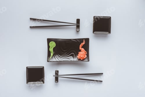 Preview: top view of chopsticks and wasabi with ginger for eating sushi isolated on white