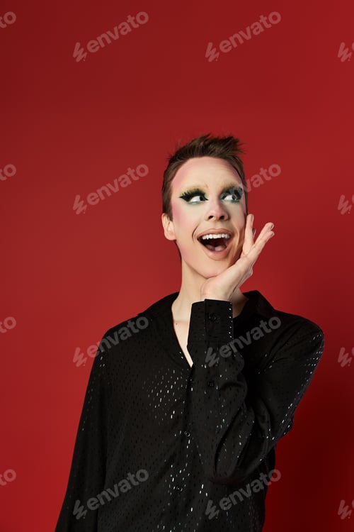 Preview: Young Drag Artist Poses Elegantly Against a Vibrant Red Background