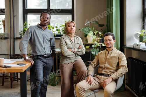 Preview: Portrait of three young intercultural coworkers in smart casualwear