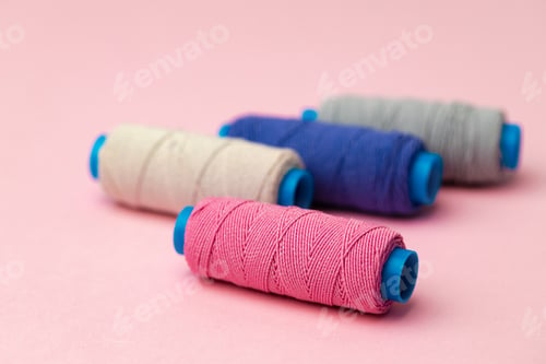 Preview: Set of threads spools on pink background