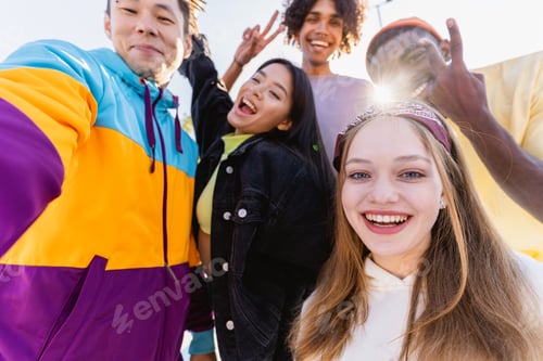 Preview: Multiracial group of young friends bonding outdoors