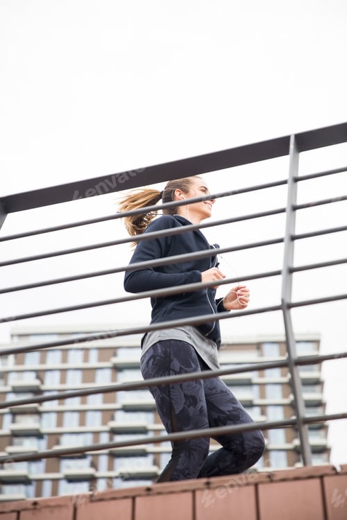 Preview: Young woman workout by fence