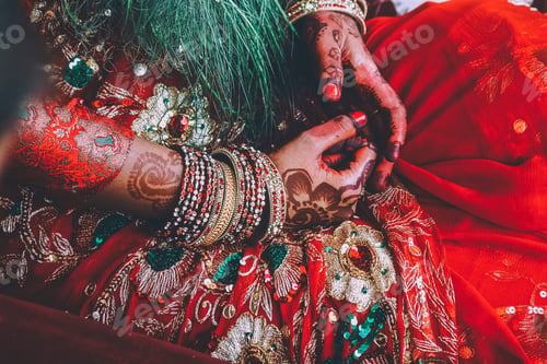 Preview: close-up partial view of woman in traditional clothes and mehendi on hands in Nepal