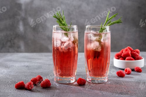 Preview: Summer refreshing alcoholic cocktails. Raspberry lemonade garnished with fresh rosemary.