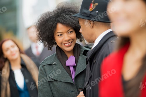 Preview: City life. A group of people on the go,on the street. A man and woman standing close together.