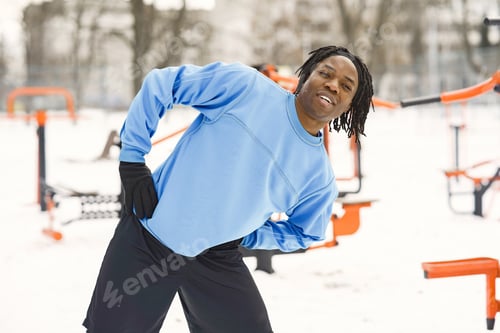 Preview: African american man doing exercise on winter day