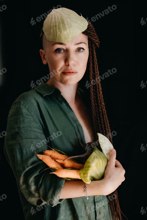 Preview: Creative portrait of vegan woman holding vegetables. Veganism, vegetarianism, plant-based diet