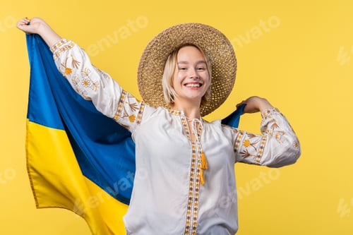 Preview: Happy woman with national Ukrainian flag on yellow. Ukraine, patriot, victory in war celebration