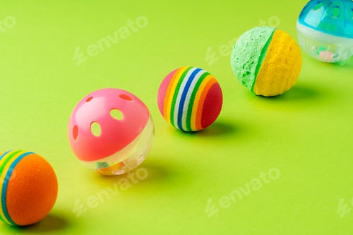 Preview: Colorful pet toys balls on green background