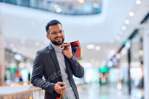 Preview: Young happy man in a shopping mall looking at camera.