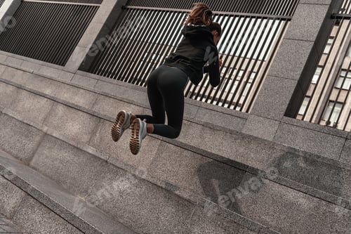 Preview: Young woman doing leg exercises with stone stairs
