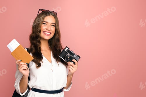 Preview: Smiling Young Woman Holding Passport and Camera Ready for Vacation