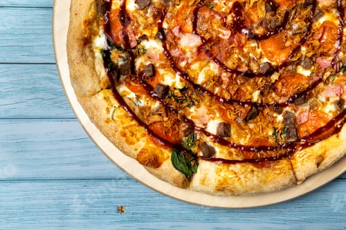 Preview: Delicious large pizza with bacon and spinach on a blue wooden background