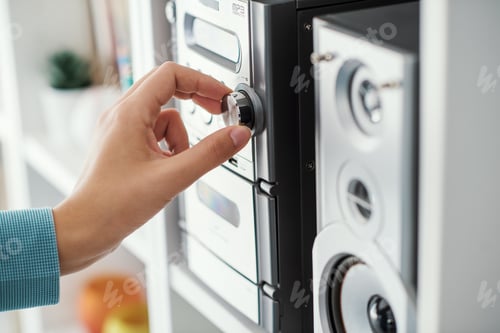Preview: Woman adjusting a knob on the stereo system