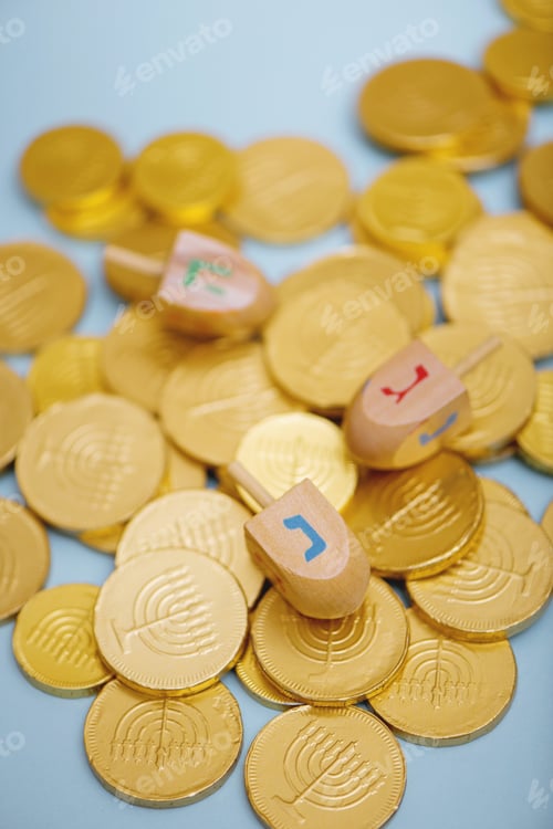Preview: Closeup of dreidel and Hanukkah gelt.