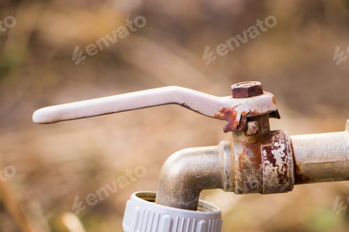 Preview: Old rusty water faucet. Abandoned device for watering plants in a greenhouse.