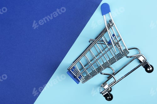 Preview: Empty shopping trolley on color background, top view. Space for text