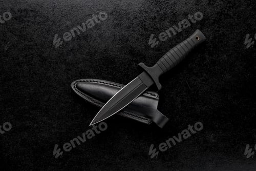 Preview: Closeup shot of a fixed military knife with a black holder and a case on a black background