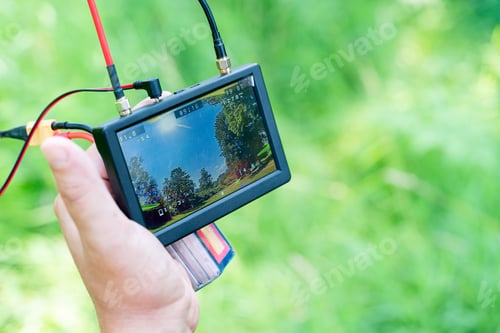 Preview: Display for monitoring the flight of a drone in male hands close-up