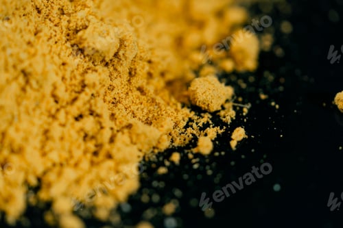 Preview: close-up on dark blue background with side lighting lies indian spices yellow turmeric oriental