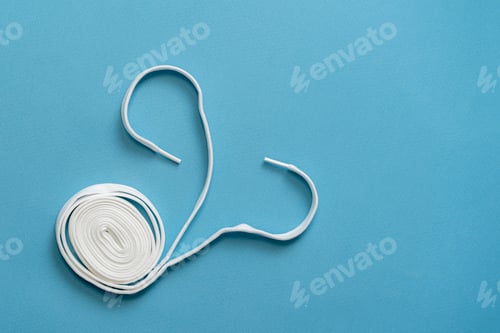 Preview: a new pair of white shoelaces flat lay, foot shoes fashion
