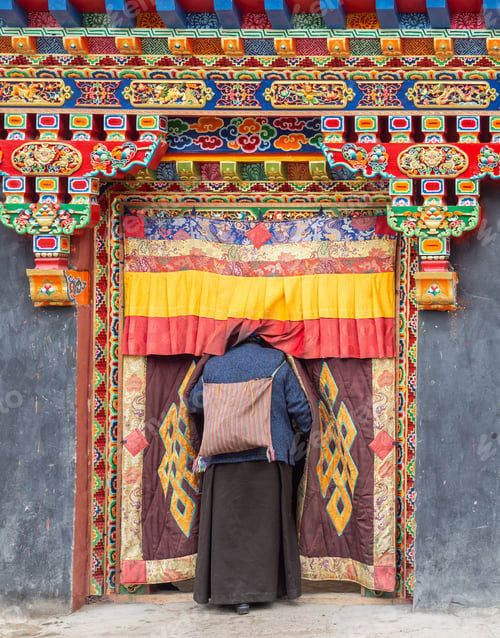 Preview: Tibet - August, 29 2014: Anonymous woman entering temple