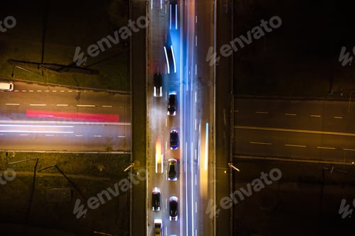 Preview: Aerial view of road intersection with fast moving heavy traffic at night. Top view of urban