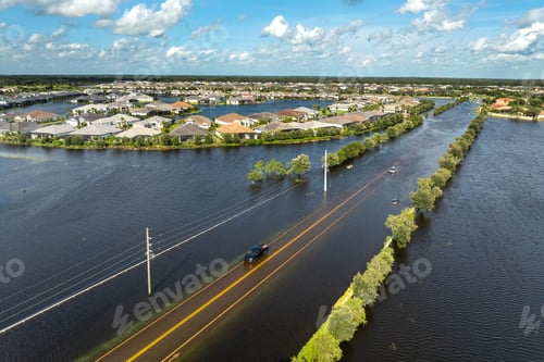 Preview: Hurricane flooded car on city street in surrounded with water Florida residential area.